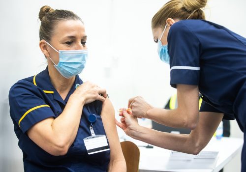 Picture of a nurse getting the Covid vaccine