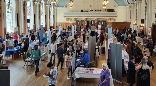 People visiting the stalls at a health and social care recruitment fair in Stockport Town Hall