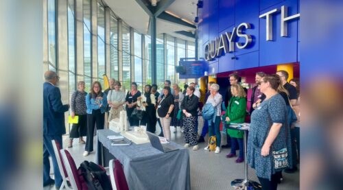 A group of people all stood around at an event