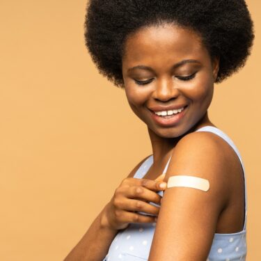 Person with a plaster covering recent vaccine.