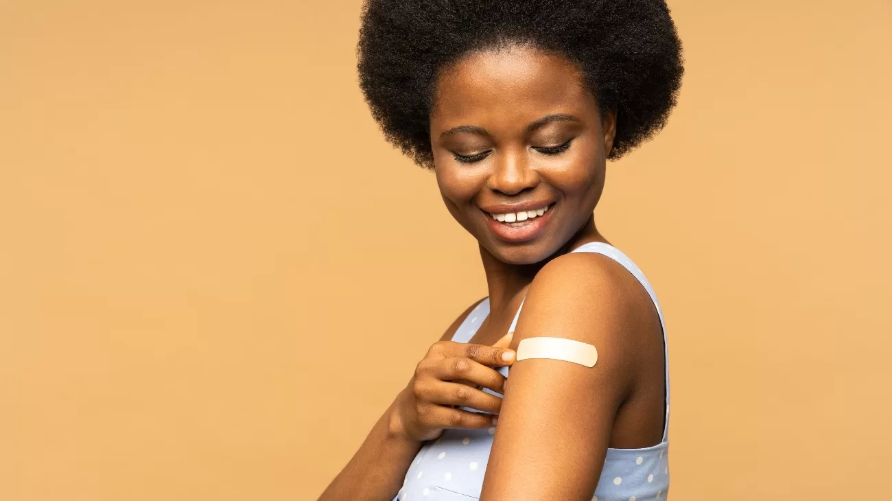 Person with a plaster covering recent vaccine.