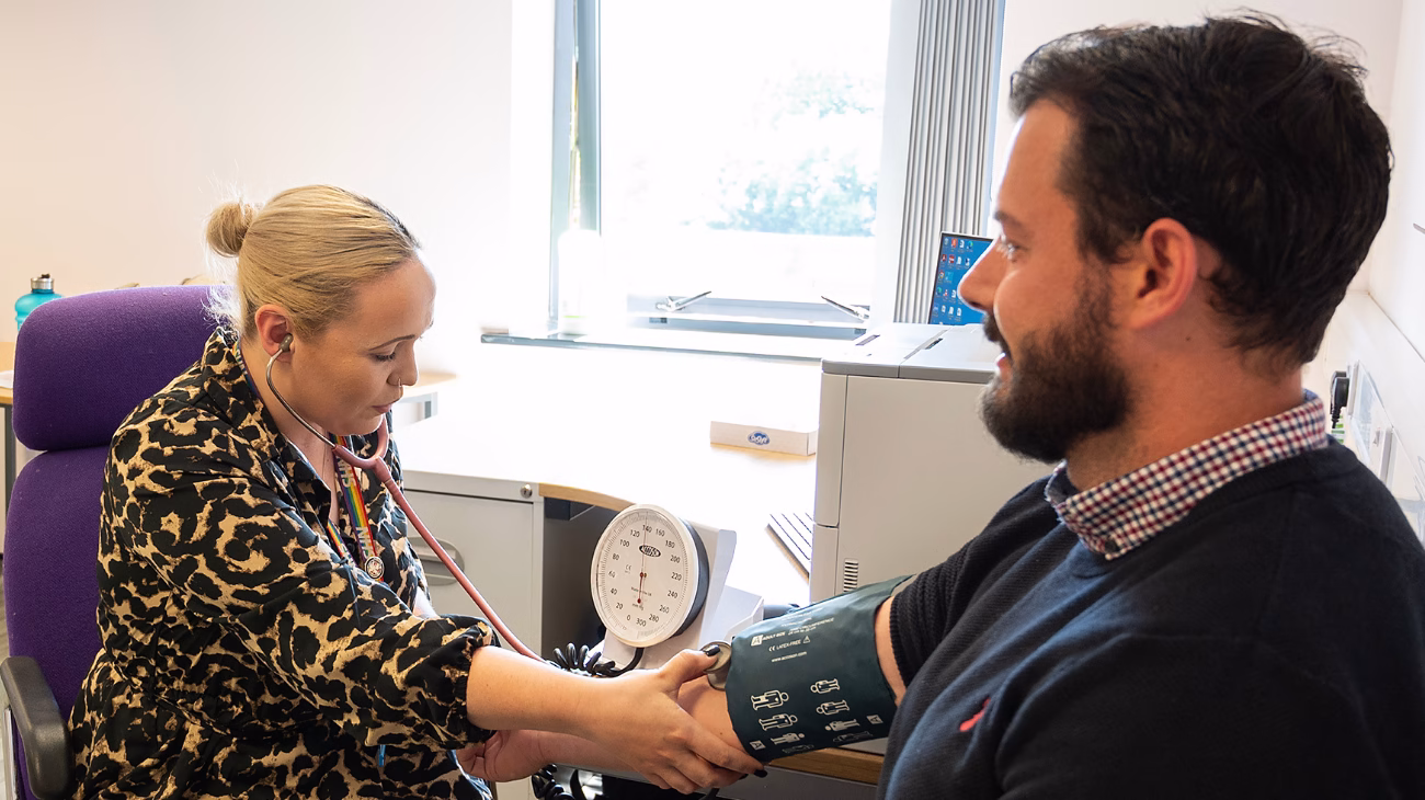 Patient having their blood pressure taken during a physical health check