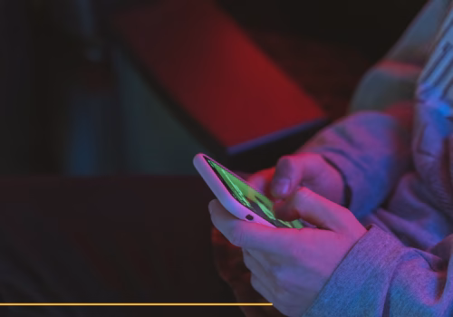 Close up of a person's hands holding a mobile phone.