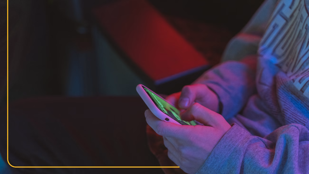 Close up of a person's hands holding a mobile phone.
