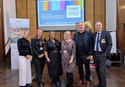 NHS GM senior leaders stood in the main hall at the careers fair.