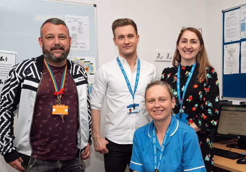 Image of a primary care team stood in an office