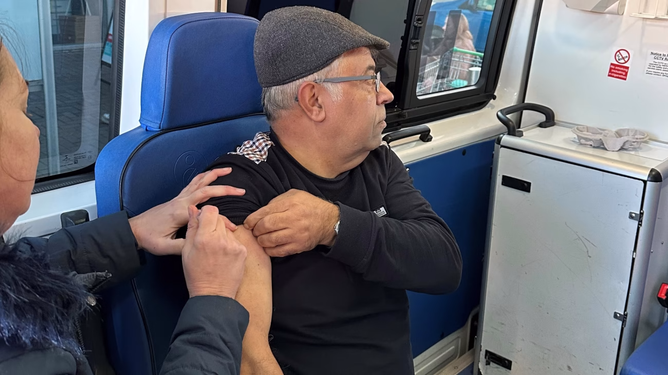 Person having flu jab in an outreach van clinic in Greater Manchester,