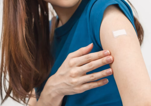 Arm with plaster after vaccine
