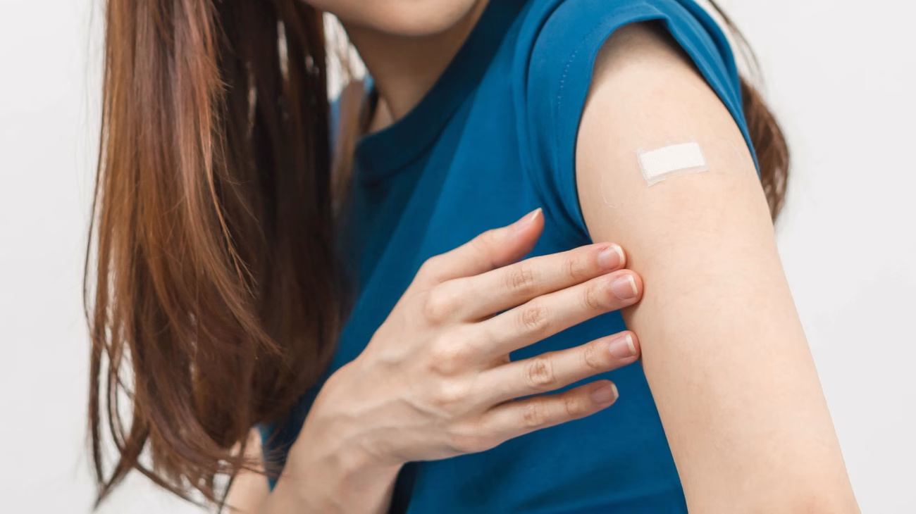 Arm with plaster after vaccine