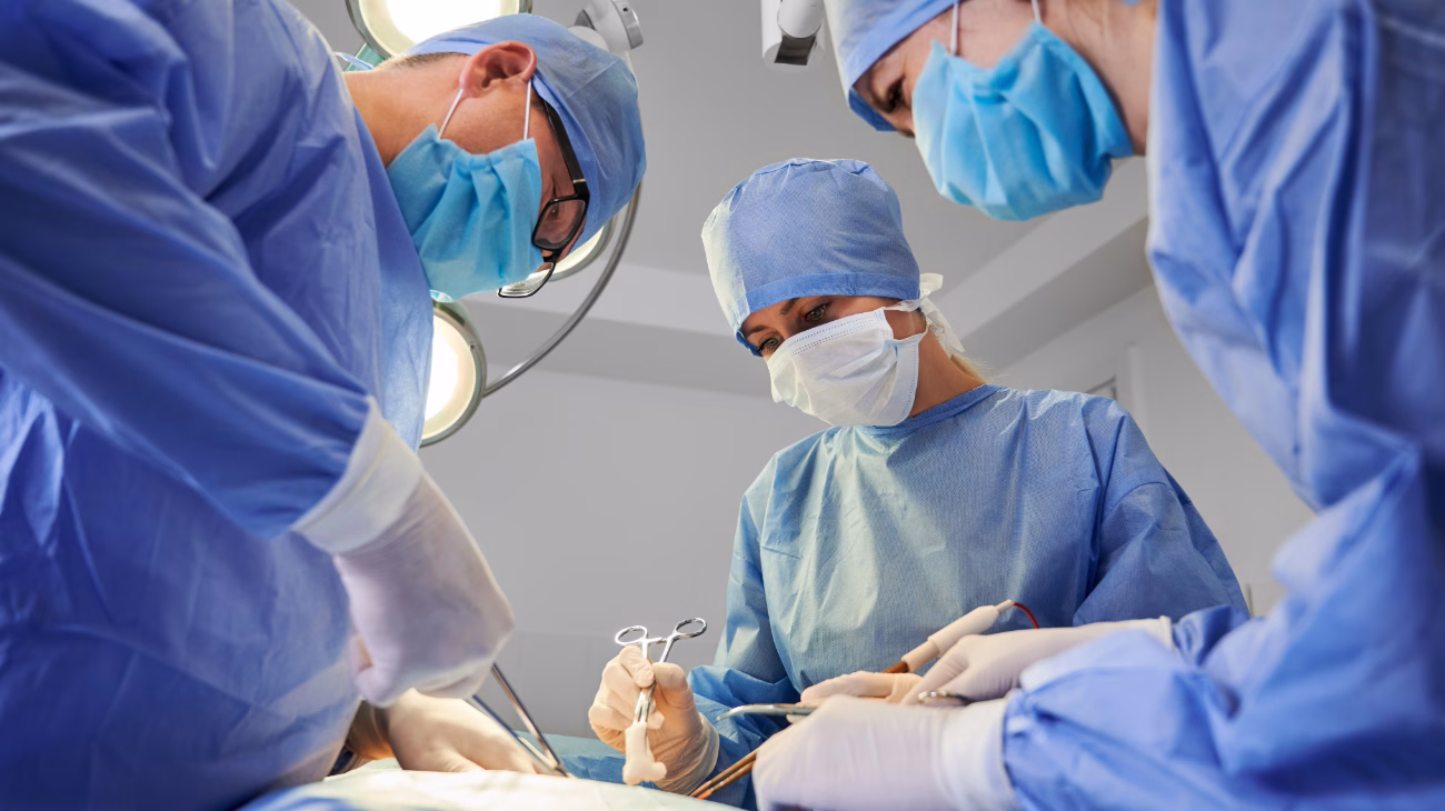 Three surgeons performing surgery
