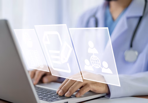 Doctor on computer looking at patient files